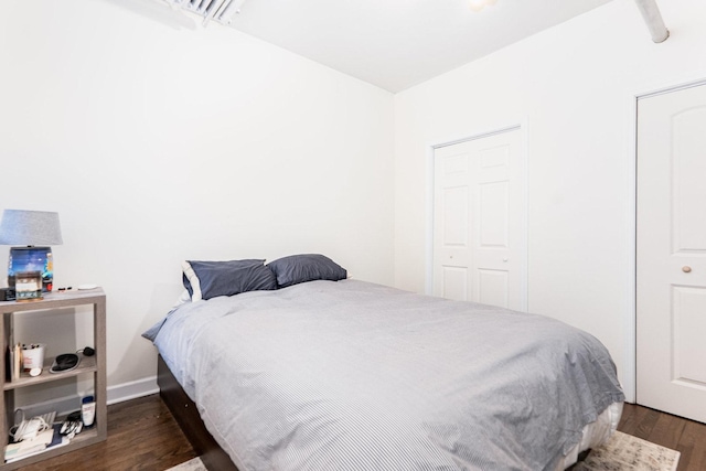 bedroom featuring visible vents and wood finished floors