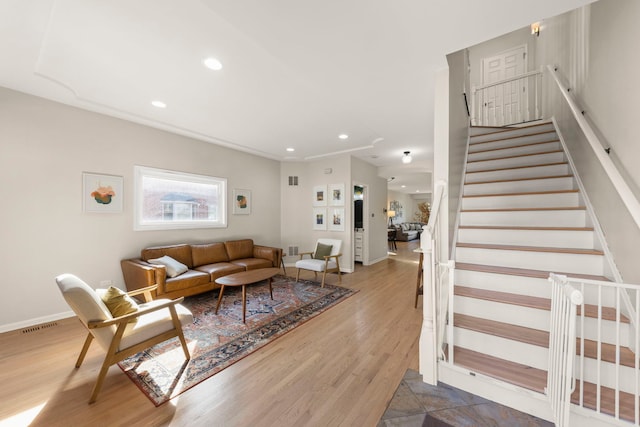 living room with visible vents, baseboards, stairway, recessed lighting, and wood finished floors