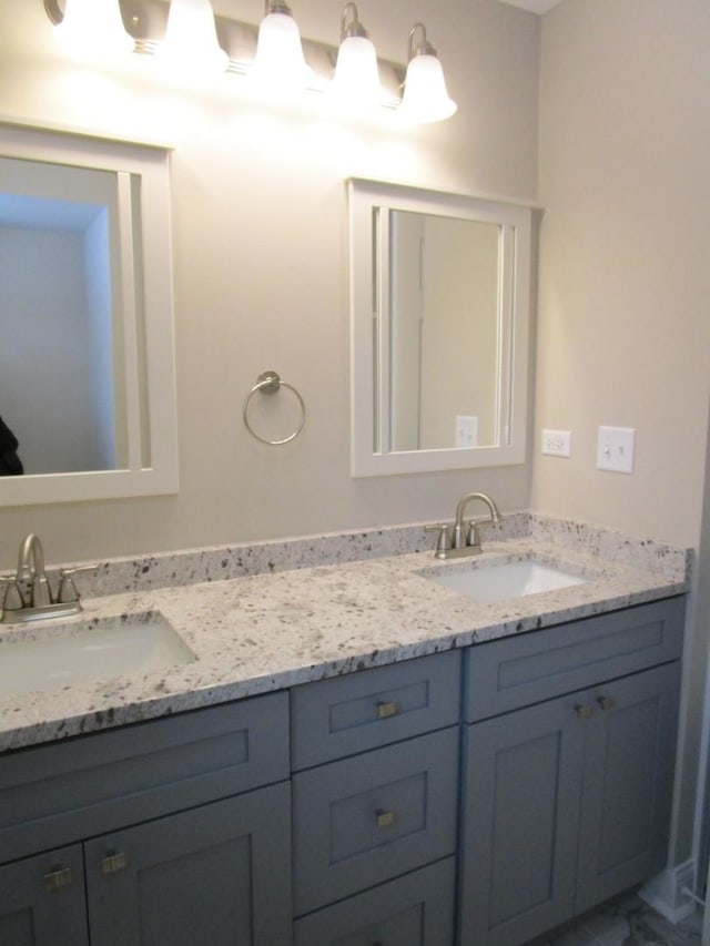 full bathroom featuring double vanity and a sink