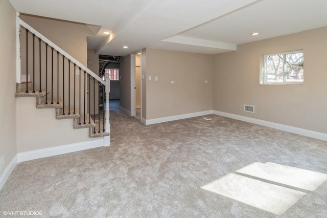 below grade area with recessed lighting, visible vents, baseboards, and stairs