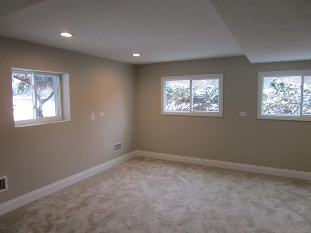 spare room with light carpet, visible vents, baseboards, and recessed lighting