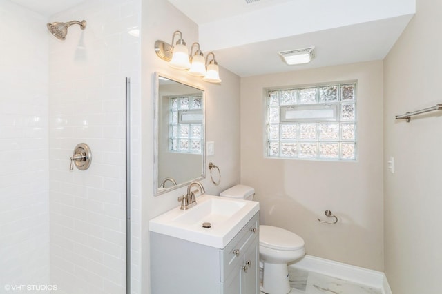 bathroom featuring baseboards, tiled shower, toilet, marble finish floor, and vanity