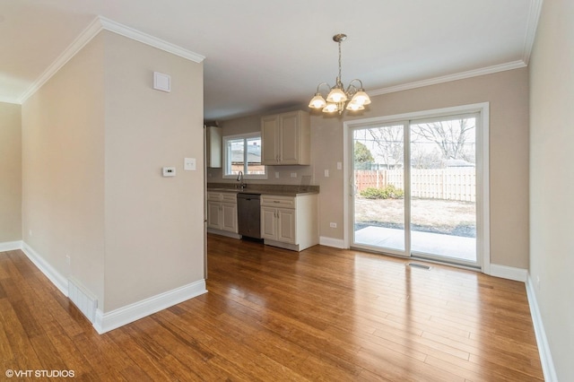 kitchen with a notable chandelier, visible vents, baseboards, stainless steel dishwasher, and light wood finished floors