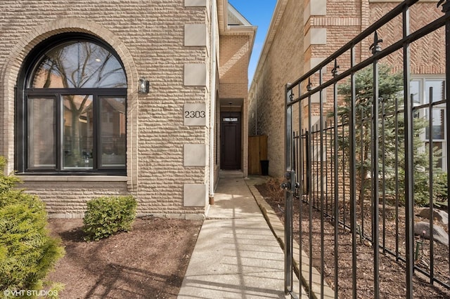 property entrance featuring brick siding