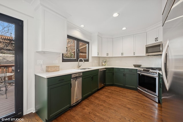 kitchen featuring a sink, white cabinetry, appliances with stainless steel finishes, green cabinets, and light countertops