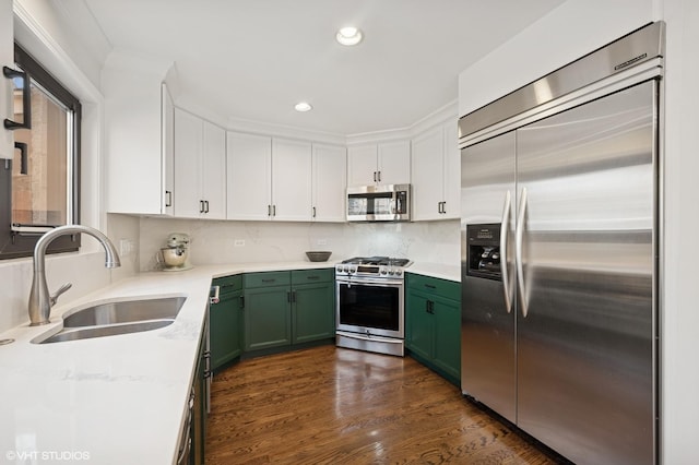 kitchen with a sink, dark wood-style floors, white cabinetry, stainless steel appliances, and green cabinetry