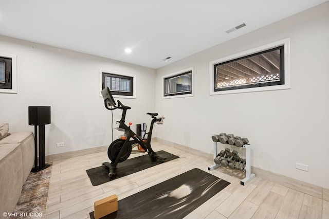 workout area featuring recessed lighting, visible vents, baseboards, and wood finished floors