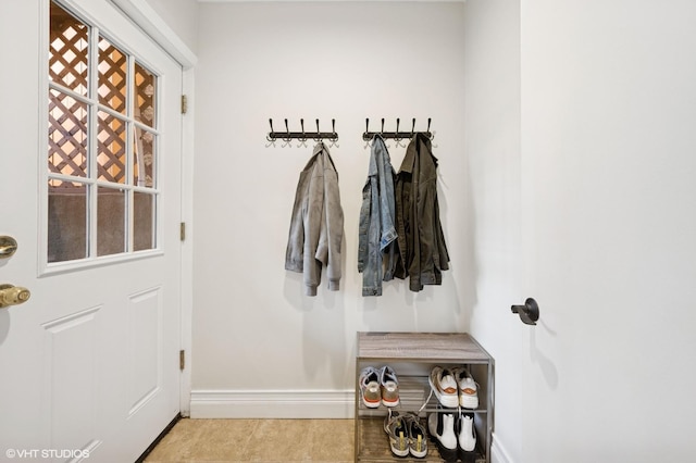 mudroom with tile patterned flooring and baseboards