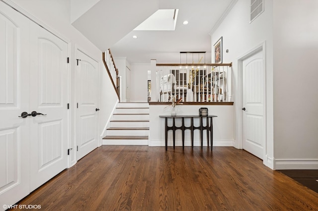 interior space with visible vents, wood finished floors, recessed lighting, stairway, and crown molding