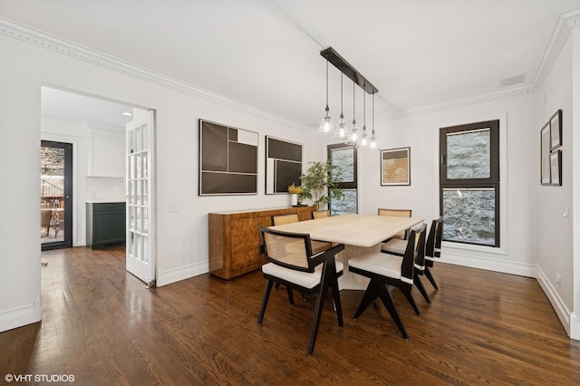 dining area featuring visible vents, baseboards, dark wood finished floors, and crown molding