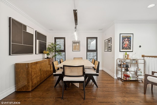 dining space featuring dark wood-style floors, baseboards, and ornamental molding