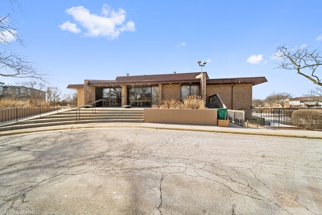 view of front of property featuring fence