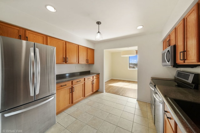 kitchen with dark countertops, brown cabinets, and stainless steel appliances