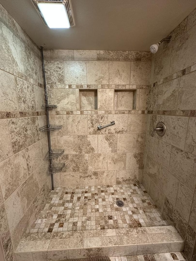 full bath featuring a tile shower