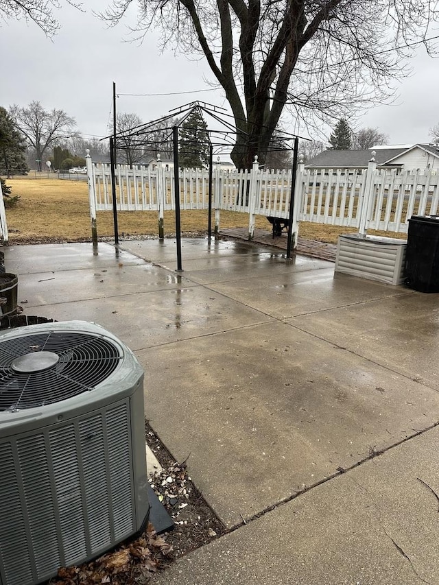 exterior space featuring central AC and fence