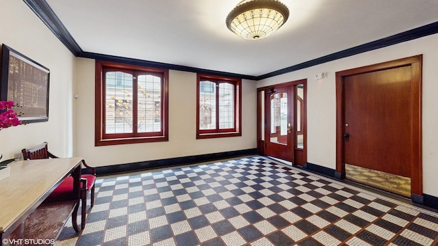 entrance foyer with baseboards, carpet floors, and ornamental molding