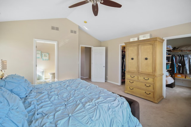 bedroom featuring vaulted ceiling, visible vents, and a walk in closet