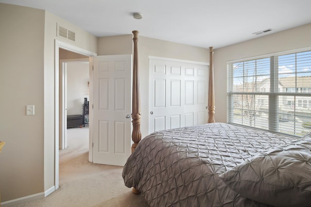 bedroom featuring light carpet, baseboards, visible vents, and a closet