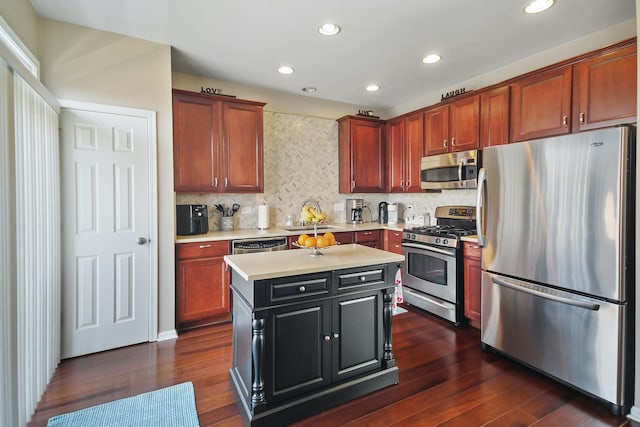 kitchen featuring stainless steel appliances, dark wood finished floors, a sink, and light countertops