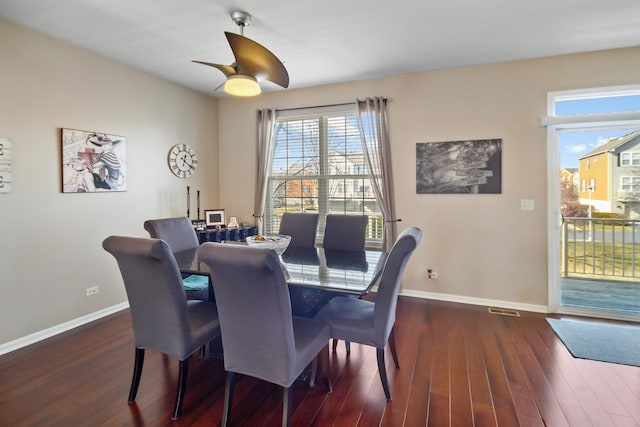 dining room featuring dark wood-style flooring, ceiling fan, and baseboards