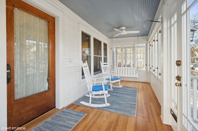 sunroom featuring a ceiling fan