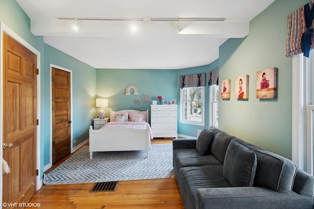 bedroom with visible vents, baseboards, and light wood-style flooring