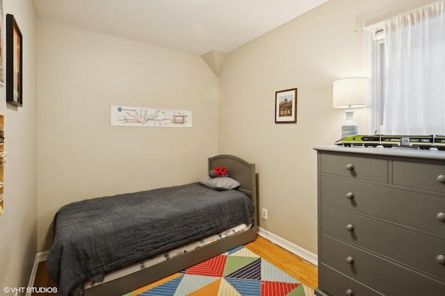 bedroom with light wood-type flooring and baseboards