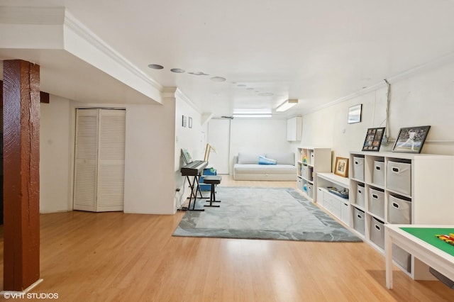 interior space with crown molding and wood finished floors