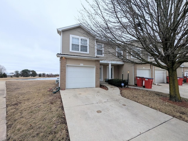 traditional-style house featuring driveway, brick siding, and an attached garage