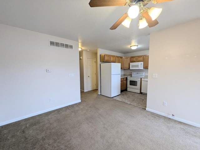 kitchen featuring light countertops, visible vents, light carpet, white appliances, and baseboards