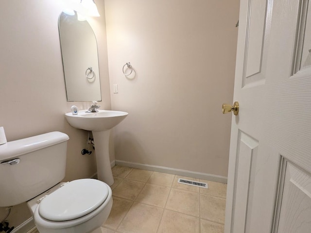 bathroom with toilet, baseboards, visible vents, and tile patterned flooring