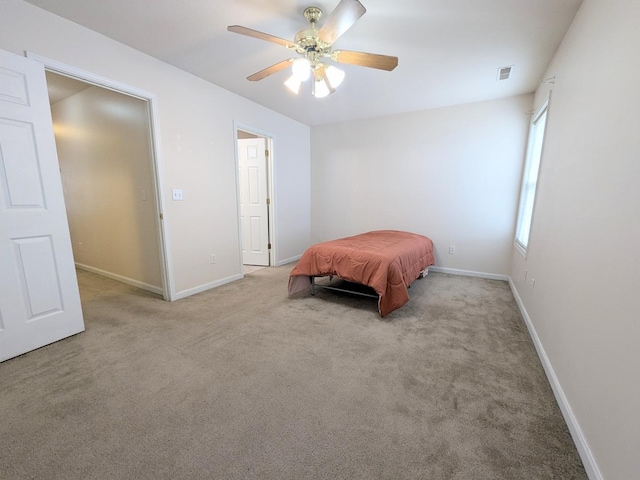 bedroom featuring ceiling fan, carpet flooring, visible vents, and baseboards