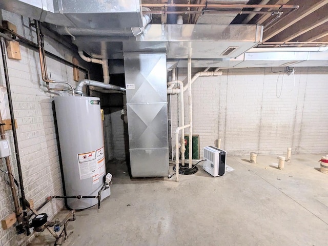 unfinished below grade area with heating unit, water heater, and brick wall