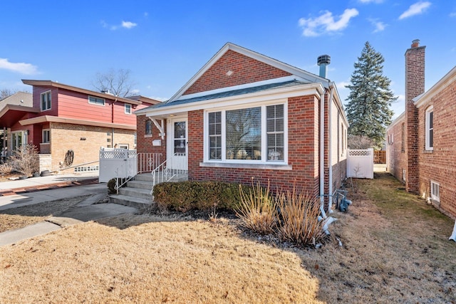 view of front of home featuring brick siding and fence