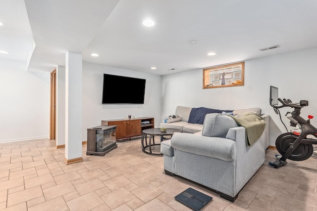 living area featuring recessed lighting, visible vents, and baseboards