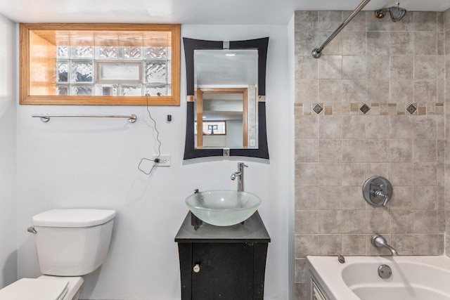 bathroom with toilet,  shower combination, and vanity