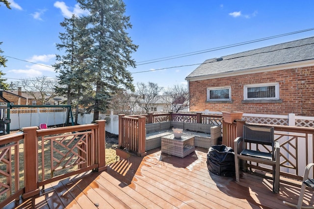 deck with an outdoor hangout area and fence