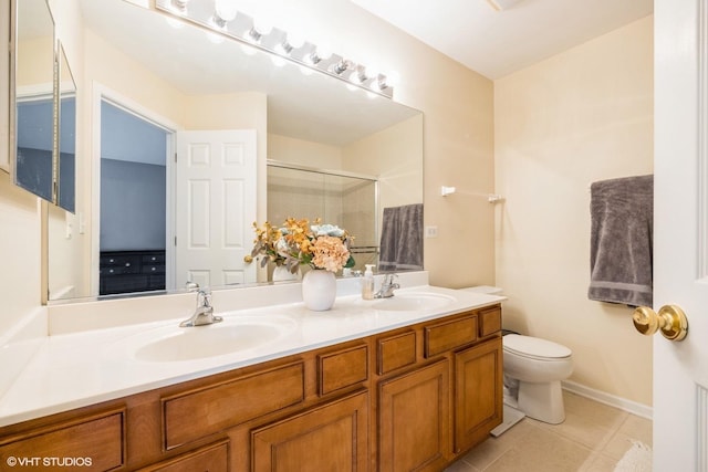 full bathroom with a sink, a shower stall, toilet, and double vanity