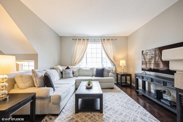 living area with baseboards and wood finished floors