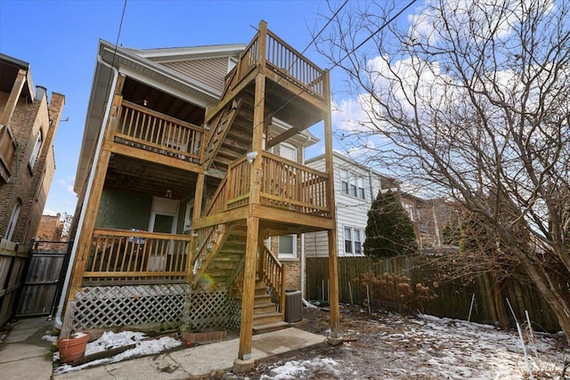 rear view of property with central AC, fence, a wooden deck, and stairs