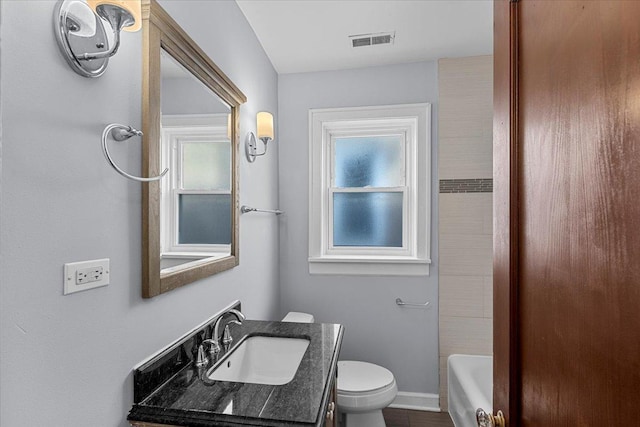 full bath featuring toilet, baseboards, visible vents, and vanity