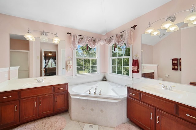 full bath with two vanities, a sink, and a bath