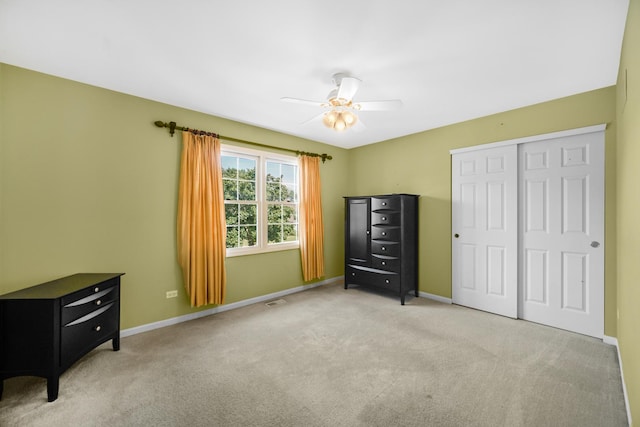 unfurnished bedroom featuring visible vents, a closet, baseboards, and carpet flooring