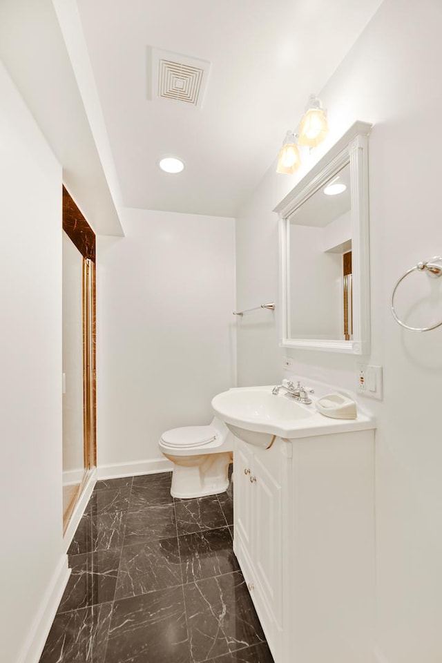 bathroom with marble finish floor, visible vents, toilet, vanity, and baseboards