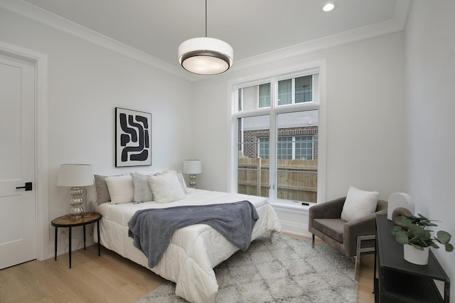 bedroom with ornamental molding, multiple windows, light wood-style flooring, and recessed lighting