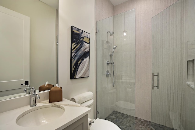 bathroom with a stall shower, vanity, and toilet