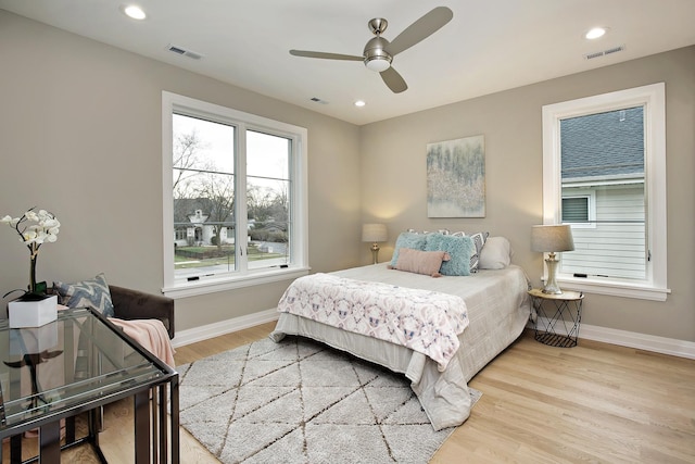 bedroom with recessed lighting, visible vents, baseboards, and wood finished floors