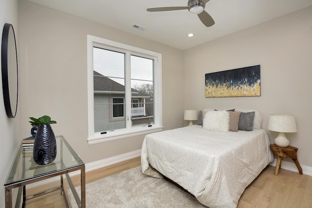 bedroom with recessed lighting, wood finished floors, visible vents, and baseboards