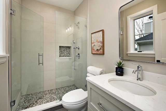 full bath featuring a shower stall, toilet, and vanity