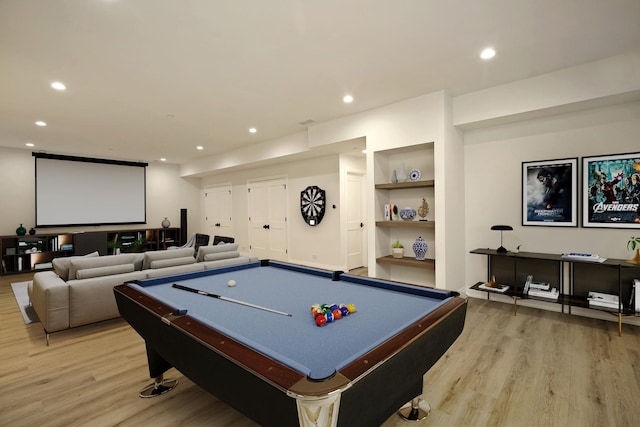 rec room featuring light wood finished floors, built in shelves, and recessed lighting